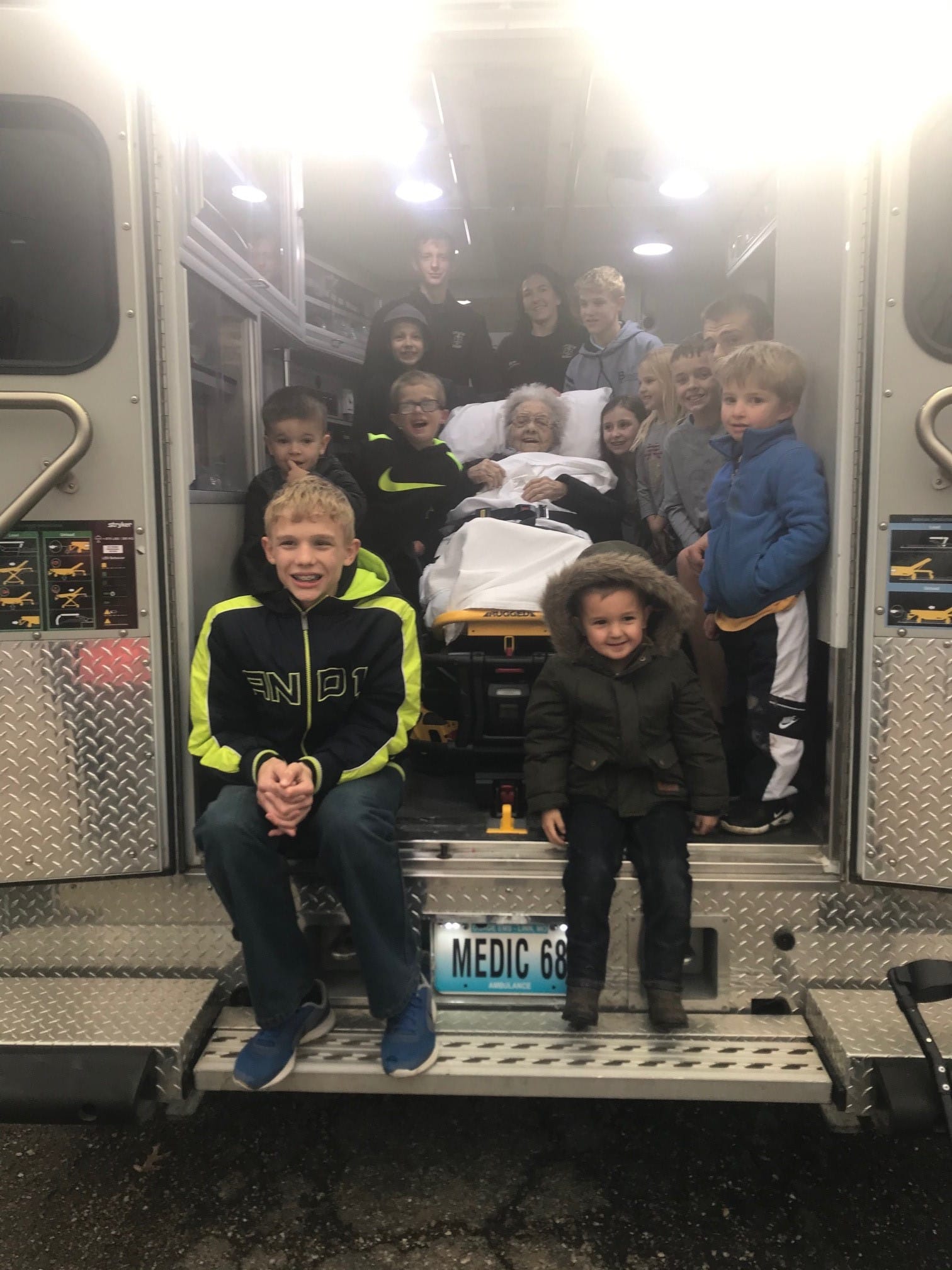 Sentimenal Program volunteers with kids and an ambulance