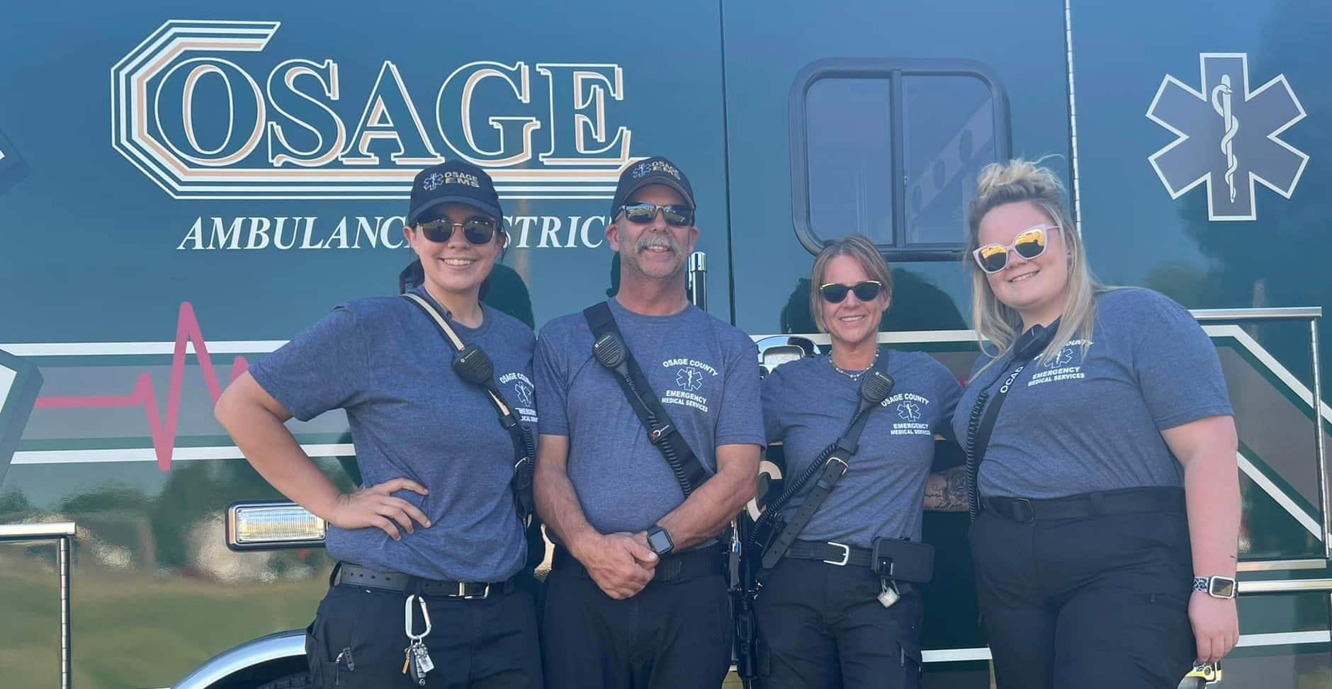 Group of Osage EMS personnel in front of an Osage ambulance